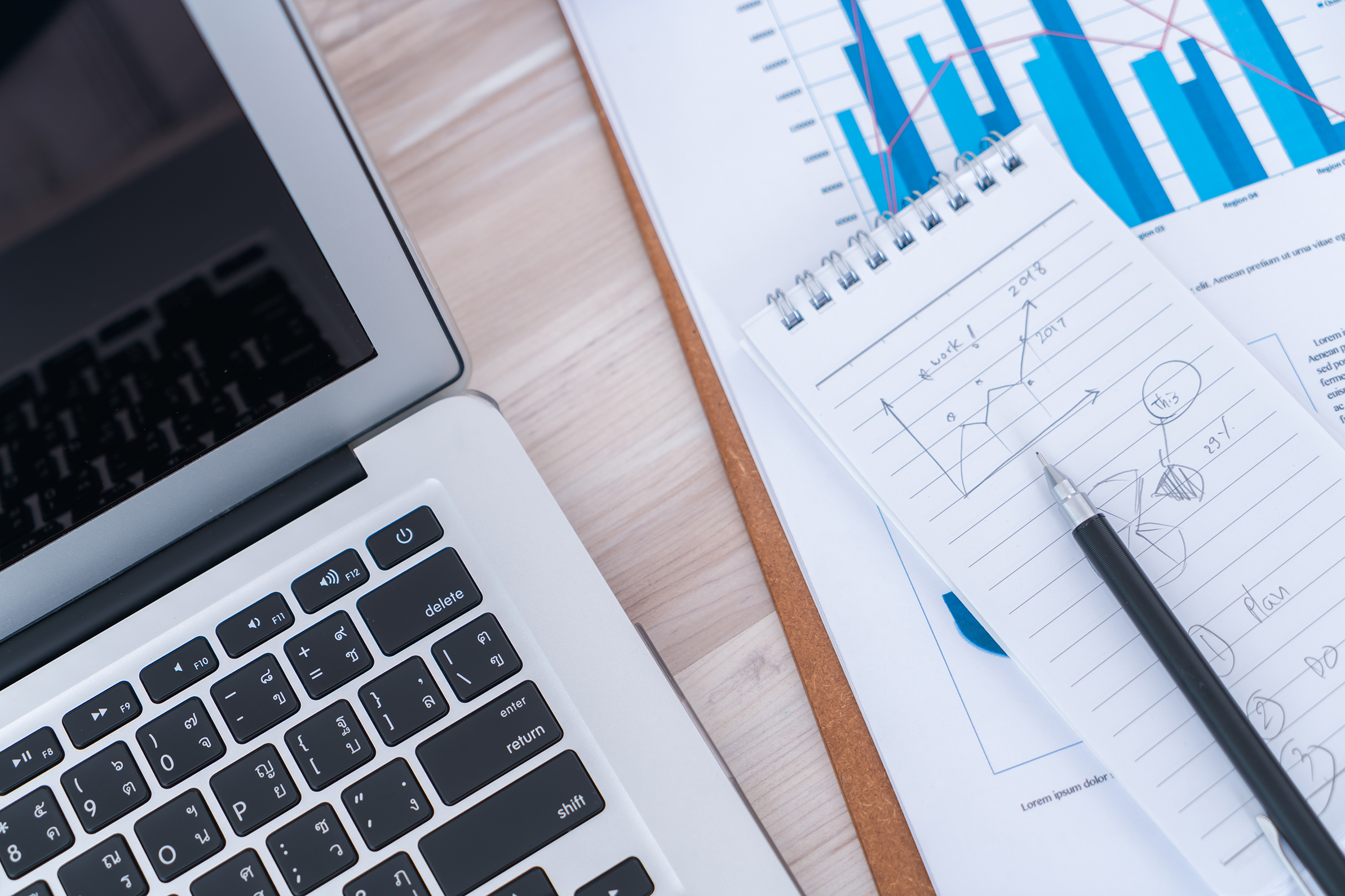 Financial charts on the table with laptop